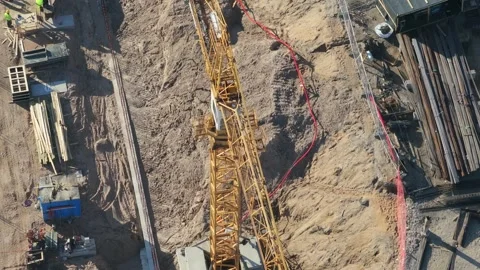 Construction crane working in the site, aerial top down view Stock Footage 335782840