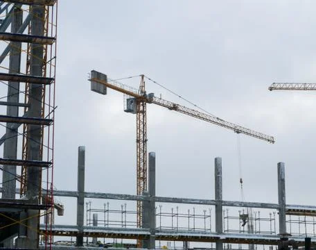 Construction crane working tower building Stock Photos