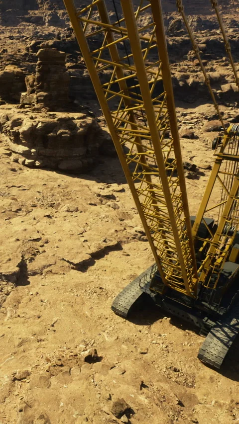 Construction crane works in a dry desert landscape during the daytime Vidéo 331759950