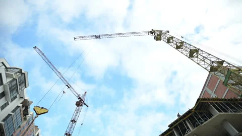 Construction cranes against blue sky. Building process of modern apartment Stock Footage 327558580