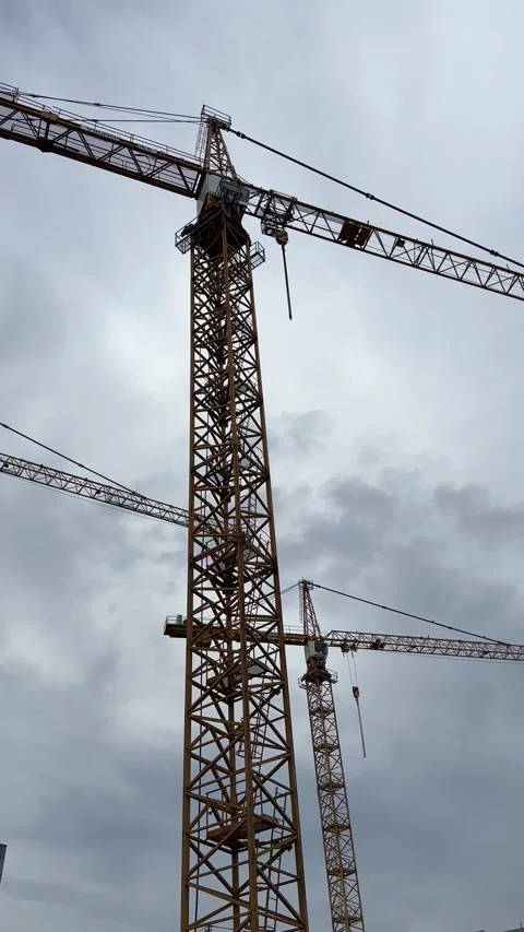 Construction Cranes Against Overcast Sky Stock Footage 344826654