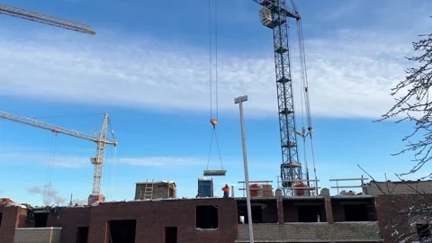 Construction cranes and builders work on the construction site outdoors 動画素材 301145511