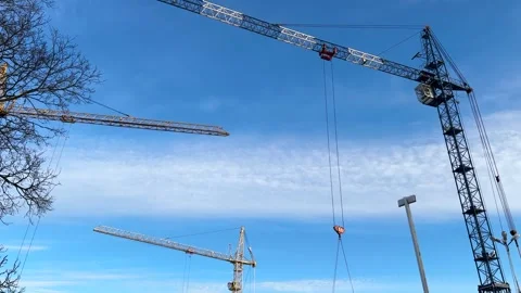 Construction cranes and builders work on the construction site outdoors Stock Footage 301337934