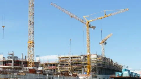 Construction cranes and shell construction of a commercial building in Hambur Video stock 135496778