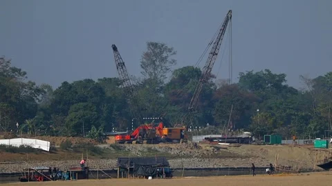 Construction cranes and workers at infrastructure development site in Dibrugarh. Stock Footage 327179546