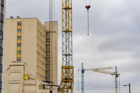 Construction cranes are actively lifting materials for a new house in an ur.. 写真素材