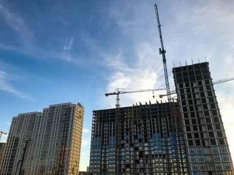 Construction cranes are erecting new houses from cellular blocks. constructio Stock Photos