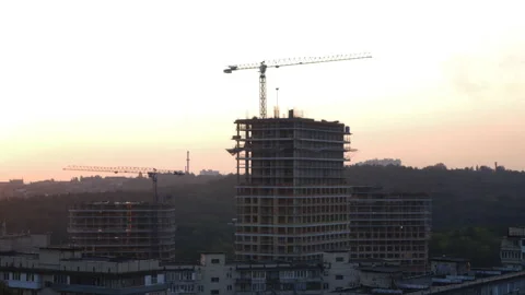 Construction cranes are erecting the walls of new buildings Stock Footage 141612888