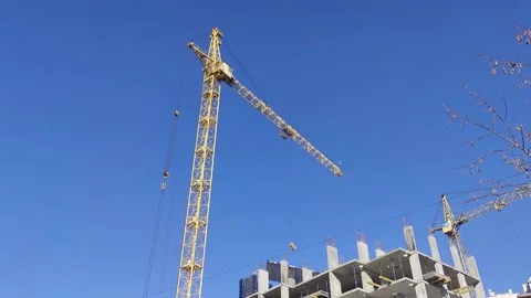Construction Cranes on the Background of the Blue Sky and the Bright Sun. Stock Footage 170378861