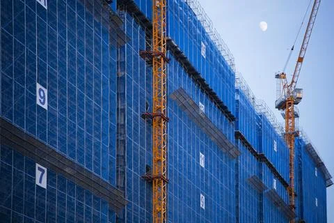 Construction Cranes Blue Scaffolding Skyscraper Moon Foto stock