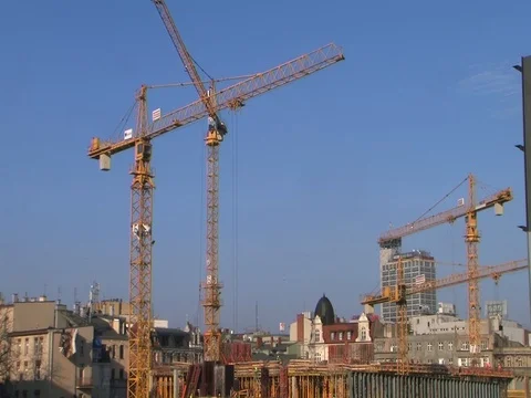Construction cranes in the blue sky during work Stock Footage 119853999