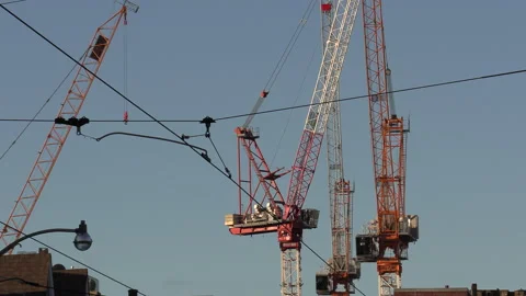 Construction cranes building condos and gentrifucation in residential area Stock Footage 144742914
