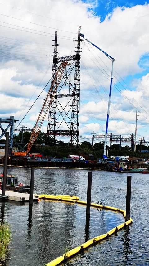 Construction cranes building high voltage power line tower 스톡 동영상 344814056