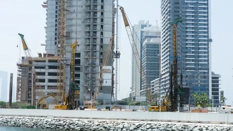 Construction cranes building modern skyscrapers in slow motion Stock Footage 291387502