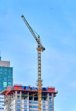 Construction cranes, construction of a modern multi-storey building Stock Photos