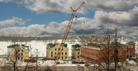 Construction cranes on construction of the nice house from a red brick Stock Photos