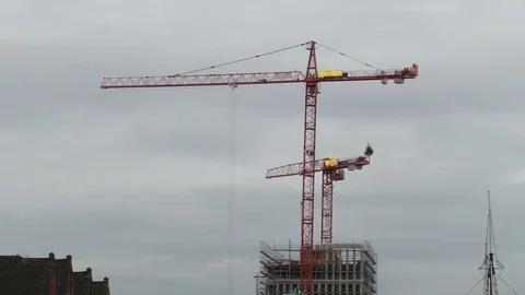 Construction Cranes on a Construction Site at dusk Stock Footage 99792292