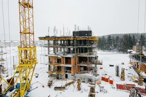 Construction cranes at the construction site of a modern neighborhood in winter Stock Photos