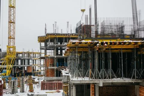 Construction cranes at the construction site of a modern neighborhood in winter Stock Photos