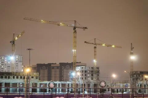 Construction cranes on the construction site Stock Photos