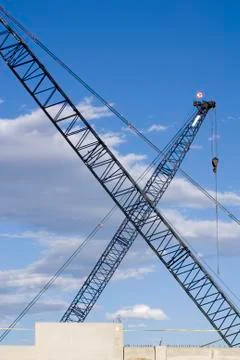 Construction cranes crossed in an x Stock Photos
