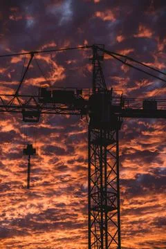 Construction Cranes Embraced by Sunset Stock Photos