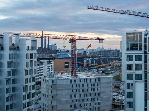 Construction cranes for new building, surrounded by apartment flats Stock Photos