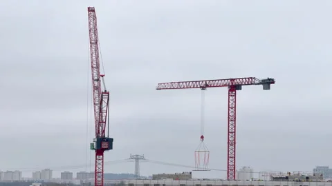 Construction cranes operating on urban building site in Berlin Germany – 4K Stock Footage 331943962