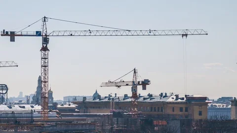 Construction cranes over the city in the evening Stock Footage 89019964