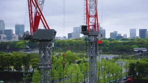 Construction Cranes over Tokyo, City Skyline in Background of Japan Stock Footage 338082144