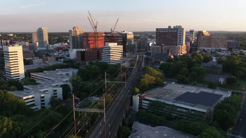 Construction cranes rise above downtown New Brunswick New Jersey at golden Stock Footage 340968975