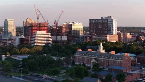 Construction cranes rise above downtown New Brunswick, New Jersey, red brick Stock Footage 340970211