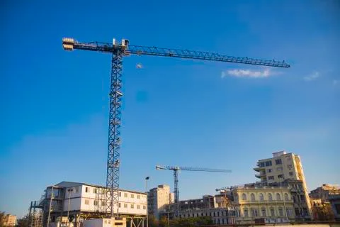 Construction cranes rise over typical colonial architecture in Old Havana, Cu Stock Photos