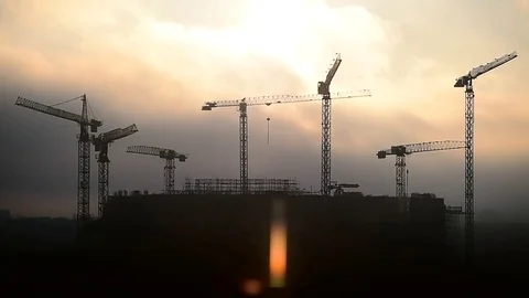 Construction cranes silhouetted against sunset sky 動画素材 72264146
