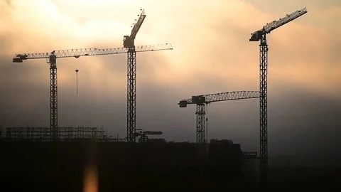 Construction cranes silhouetted against sunset sky 스톡 동영상 72264153