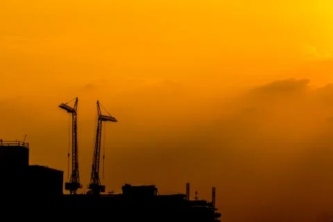 Construction cranes silhouettes Stock Photos
