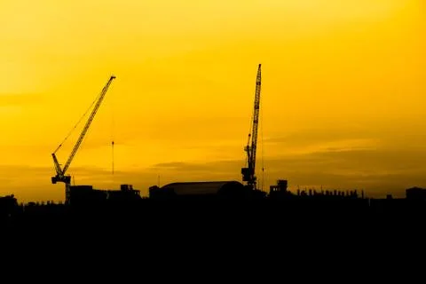 Construction cranes silhouettes Stock Photos