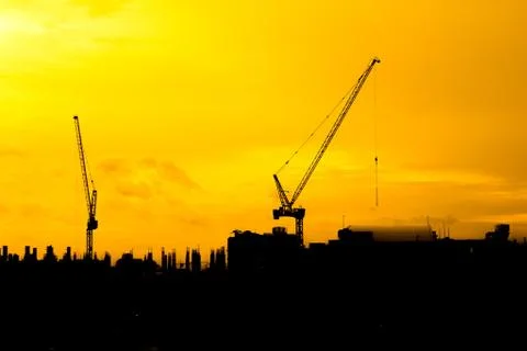 Construction cranes silhouettes Stock Photos