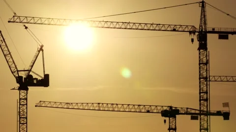 Construction cranes silhouettes at sunset light. build develop growth background Stock Footage 40632662
