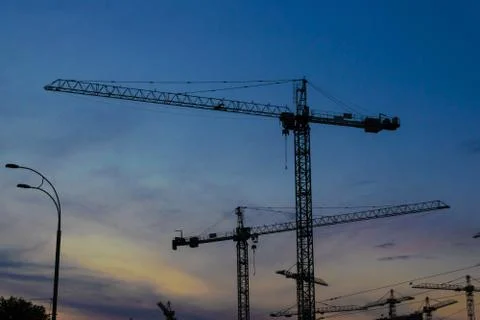 Construction cranes on sunset Foto stock