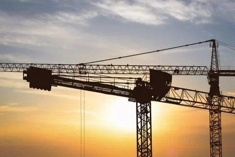 Construction cranes at sunset Foto stock