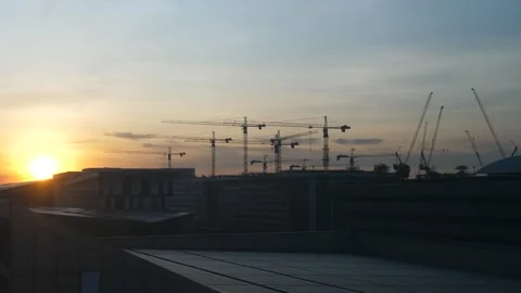 Construction cranes at sunset skyline Video stock 309978819