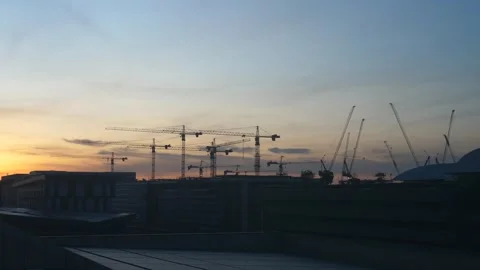 Construction cranes at sunset skyline Stock Footage 309978821