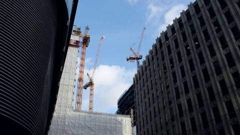 Construction cranes surrounded by buildings Stock Footage 73171946