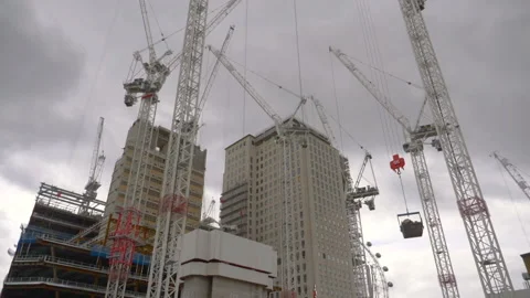 Construction cranes visible between skyscrapers in slow motion 180fps 스톡 동영상 164782262
