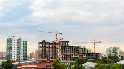 Construction cranes work on a cloudy day Stock Footage 52339247