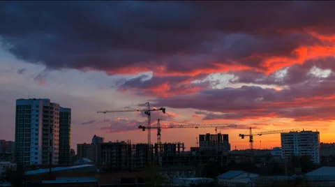 Construction cranes work on a cloudy day with thunderstorms Stock Footage 52339314