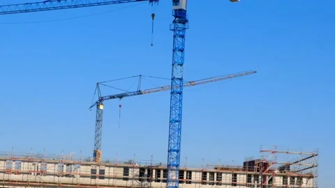 Construction cranes.Construction machinery and building under construction Stock Footage 230619290
