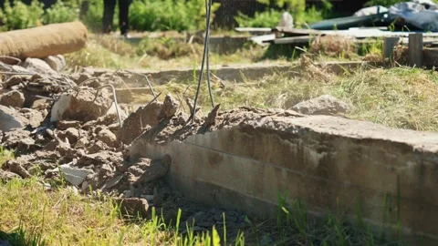 Construction crew demolishing concrete foundation with jackhammer Stock Footage 337830242