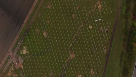 Construction crew fits solar panels on energy field, aerial view Stock Footage 320246615